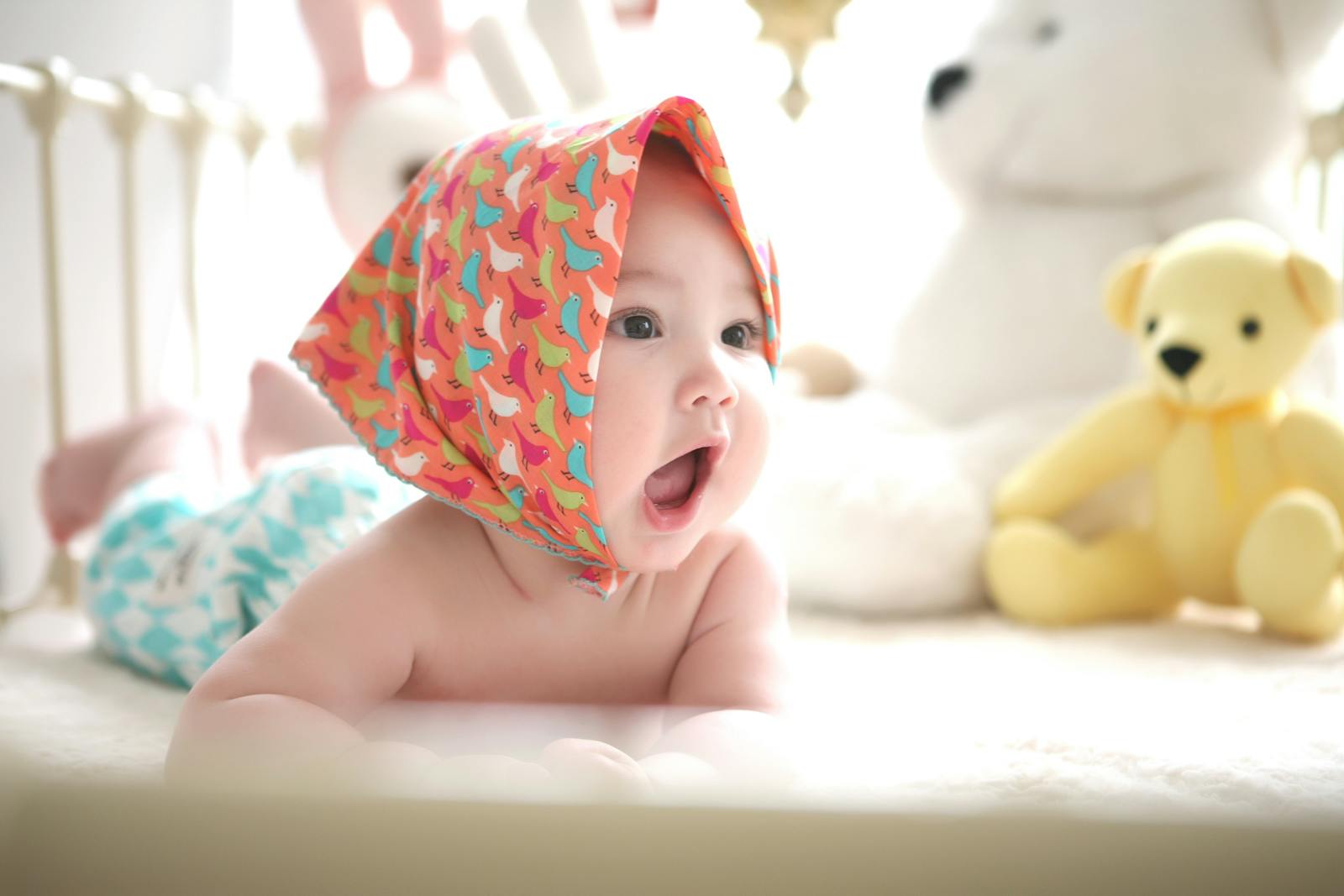 Toddler Wearing Head Scarf in Bed - Eco-Friendly Baby Products