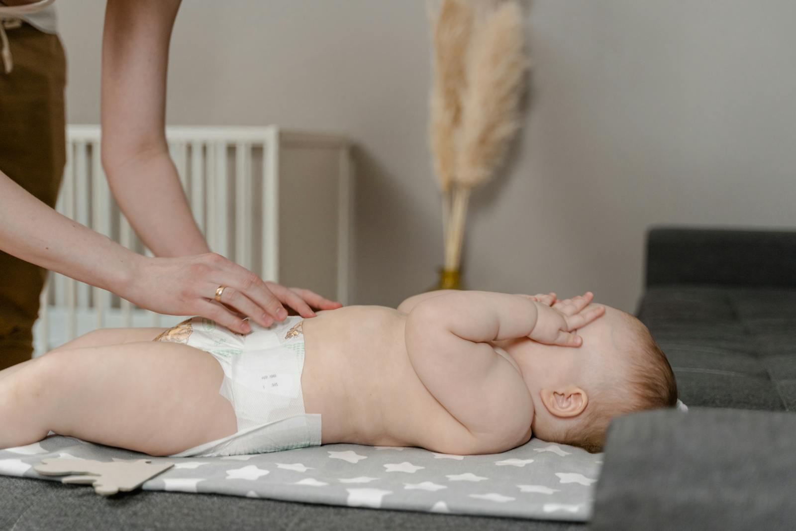 A Parent Changing the Diaper of a Baby - eco-friendly diapers