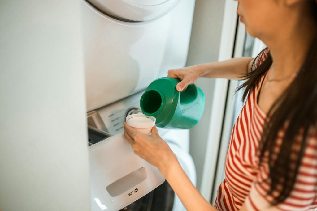 A Woman Pouring Eco-Friendly Laundry Detergents